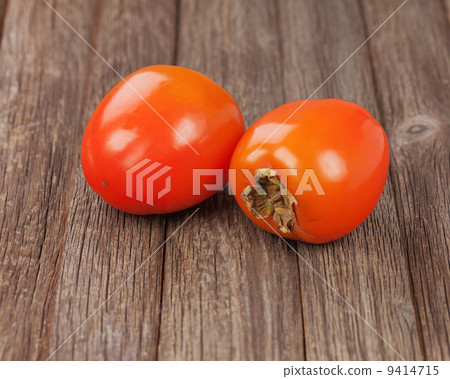 Fresh ripe persimmon on wooden table. 9414715