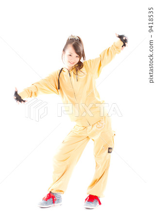 A pretty cheerful girl who dances hip-hop dance 9418535