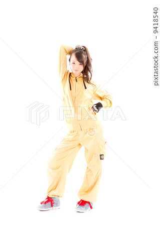 A pretty cheerful girl who dances hip-hop dance 9418540