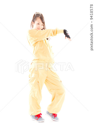 A pretty cheerful girl who dances hip-hop dance 9418578