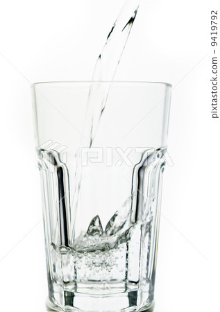 Filling a glass with water showing a drink concept 9419792