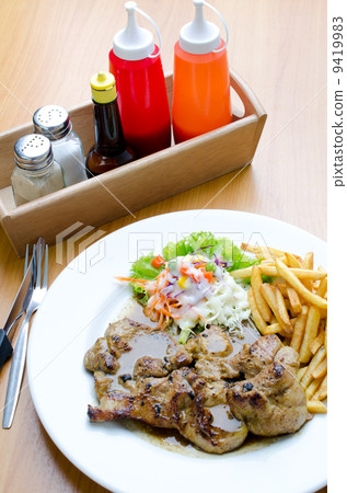 Grilled steak, French fries and vegetables Grilled steak, French fries and vegetables 9419983
