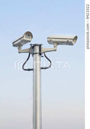 Security camera on blue sky background Security camera on blue sky background 9421022