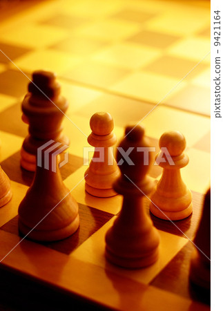 Chess pieces in yellow ambient light Chess pieces in yellow ambient light 9421164