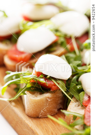 Tomato, mozzarella and arugula sandwich Tomato, mozzarella and arugula sandwich 9422654