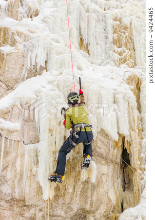 Young man climbing the ice Young man climbing the ice 9424465