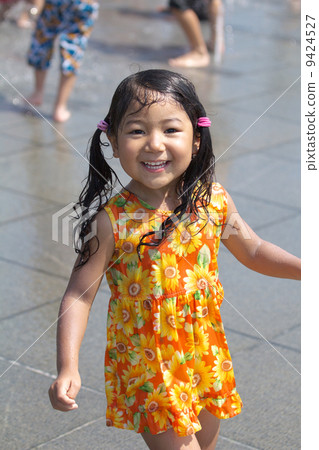 Girls playing in the fountain 9424527