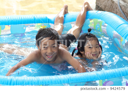 Children playing in the plastic pool 9424579