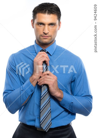 Handsome young man in blue shirt and tie isolated on white background Handsome young man in blue shirt and tie isolated on white background 9424609