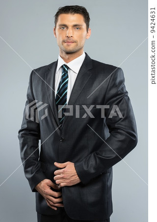 Well-dressed handsome man in black suit and tie Well-dressed handsome man in black suit and tie 9424631