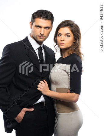 Beautiful young couple in suit and dress isolated on white background Beautiful young couple in suit and dress isolated on white background 9424632