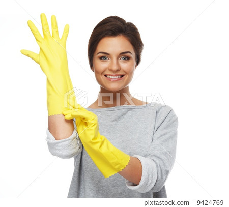 Beautiful cheerful brunette woman pulling on rubber gloves Beautiful cheerful brunette woman pulling on rubber gloves 9424769