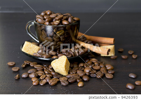 coffee beans, cup, Pots, cinnamon on dark background 9426393