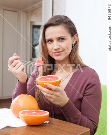 long-haired girl eats grapefruit 9426978