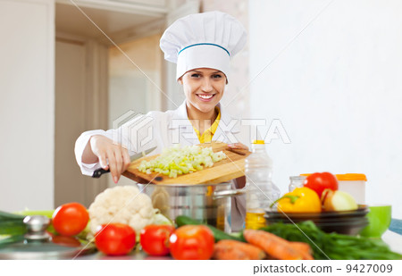 Happy cook works with vegetables Happy cook works with vegetables 9427009