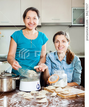 cooking mother with adult daughter cooking mother with adult daughter 9427037