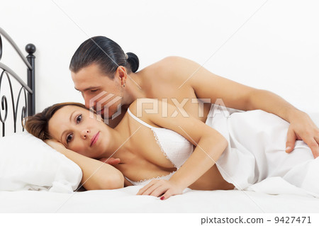 Middle-aged couple awaking in bed 9427471