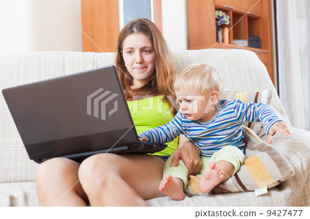 mother with baby working online mother with baby working online 9427477