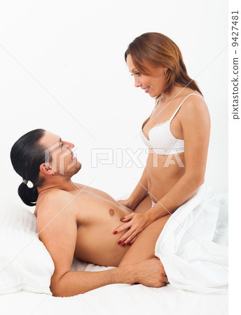 Smiling couple in bed 9427481