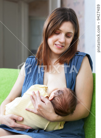 Smiling mother breast feeding baby Smiling mother breast feeding baby 9427489