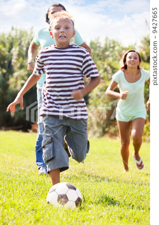 boy with parents playing in soccer 9427665