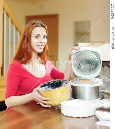 Young woman with electric slo-cooker 9427927