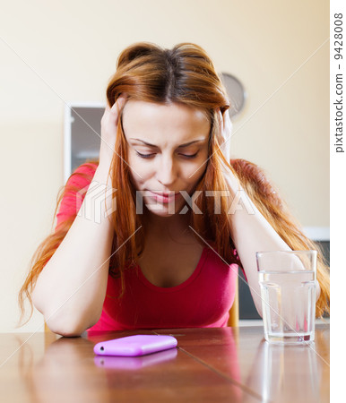 Crying red-headed lonely girl in home Crying red-headed lonely girl in home 9428008