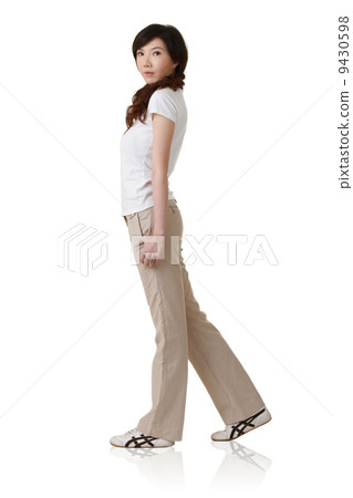 Young Asian lady walking 9430598