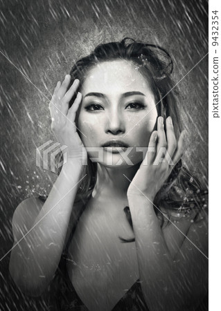 Attractive asian lady in rain 9432354