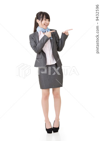 Attractive business woman showing or pointing 9432596