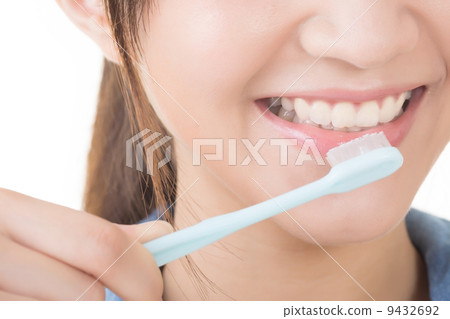 Closeup shot of woman brushing teeth Closeup shot of woman brushing teeth 9432692