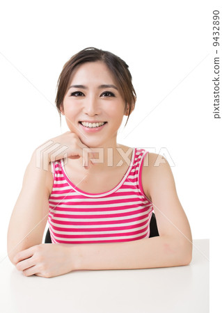 Pretty young asian girl sits on the table 9432890