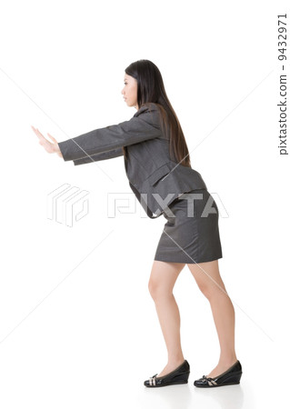 Asian business woman pushing Asian business woman pushing 9432971