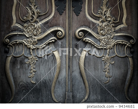 Old wooden door with beautiful decoration 9434681
