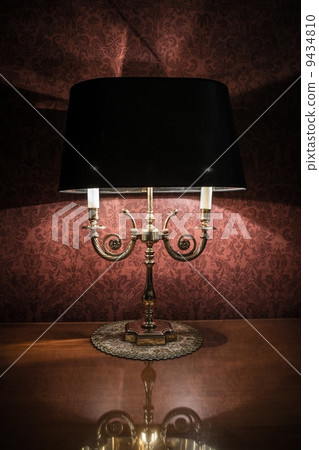 Vintage style lamp on a polished wooden table 9434810