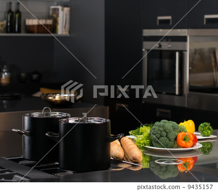Fresh vegetables and pots on a modern kitchen Fresh vegetables and pots on a modern kitchen 9435157