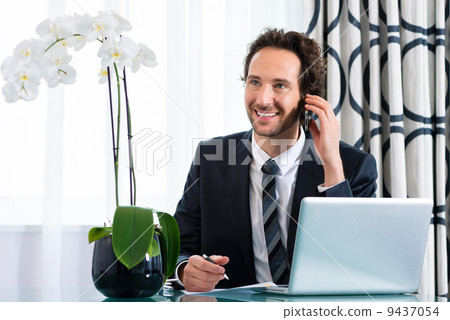 businessman in hotel is on the phone 9437054