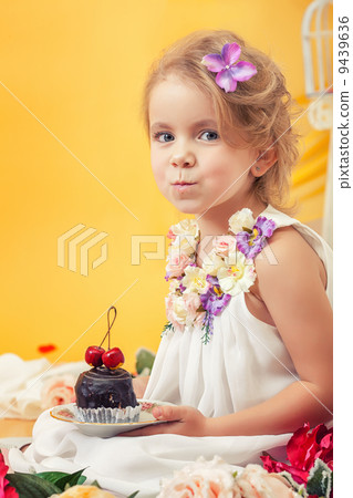 Portrait of slyly smiling girl posing with cake 9439636
