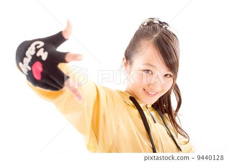 A pretty cheerful girl who dances hip-hop dance 9440128