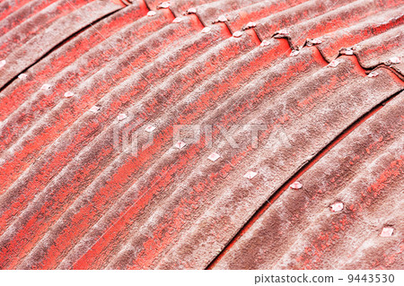 Background of old slate with tattered red paint on the roof, bok 9443530