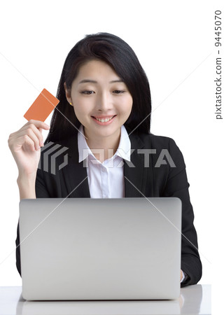 Business woman online shopping browsing laptop holding credit card studio white background 9445070