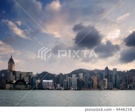 Cityscape of Victoria harbor with white cloud and blue sky in Ho 9446258