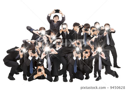 many photographers holding camera pointing to you and isolated o 9450628
