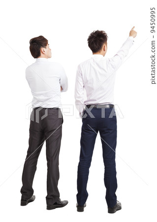 full length of two businessman pointing and looking full length of two businessman pointing and looking 9450995