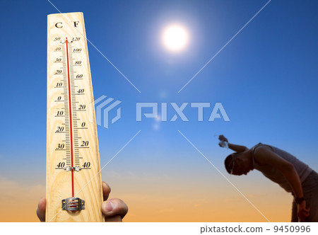man throwing water over his head for cooling under heat and summer sky 9450996