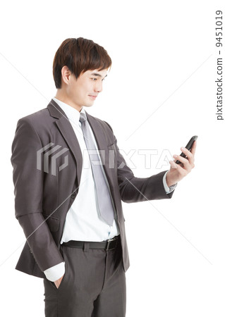 asian smart businessman holding smart phone asian smart businessman holding smart phone 9451019