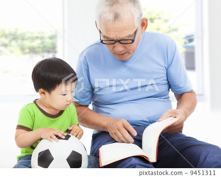 grandfather reading a story book for his grandson 9451311