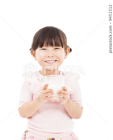 asian little girl holding a glass of fresh milk asian little girl holding a glass of fresh milk 9451312