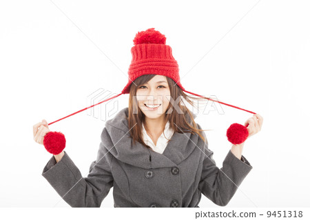 happy young woman wearing winter coat and cap 9451318