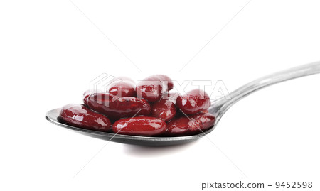 Preserve beans on a spoon. 9452598